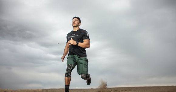 Man Fitness - Man Running on Sand Field