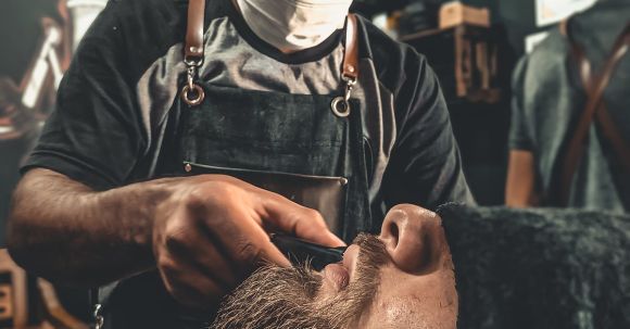 Shaving - A Barber Grooming A Man's Beard