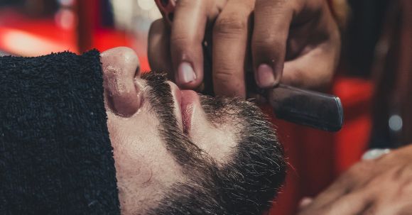 Shaving - Barber shaving a mans beard